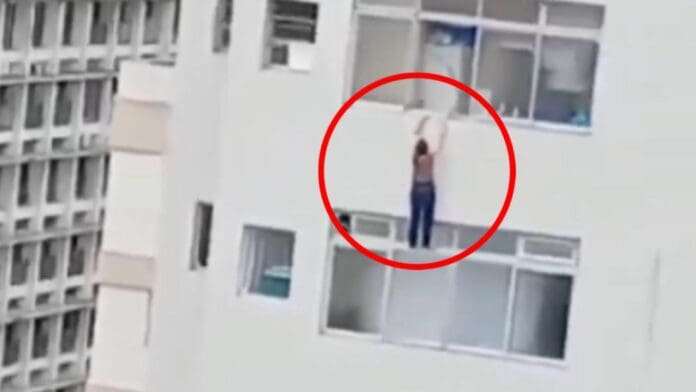 VIDEO: Mujer resbala mientras limpiaba un vidrio y queda colgando en el filo de la ventana de un piso 15